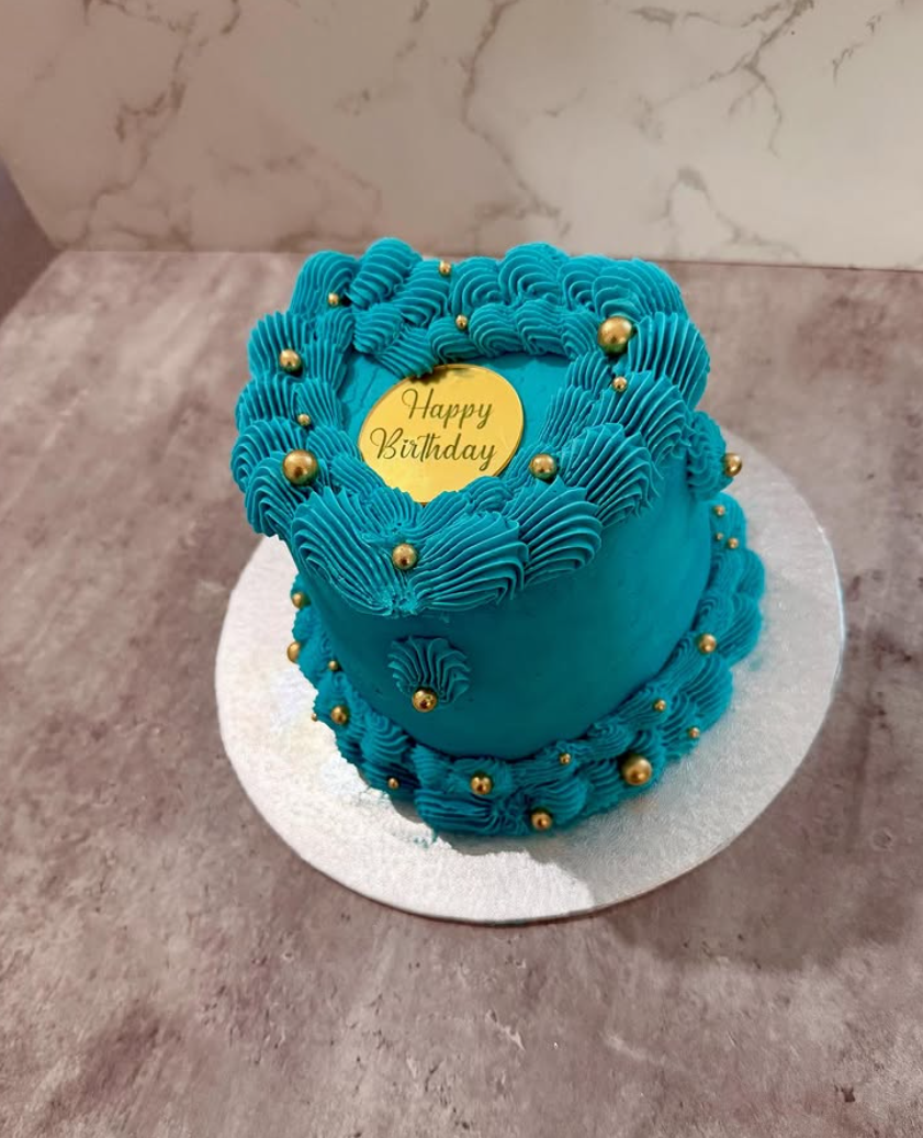Teal buttercream celebration cake with gold pearls and a Happy Birthday plaque