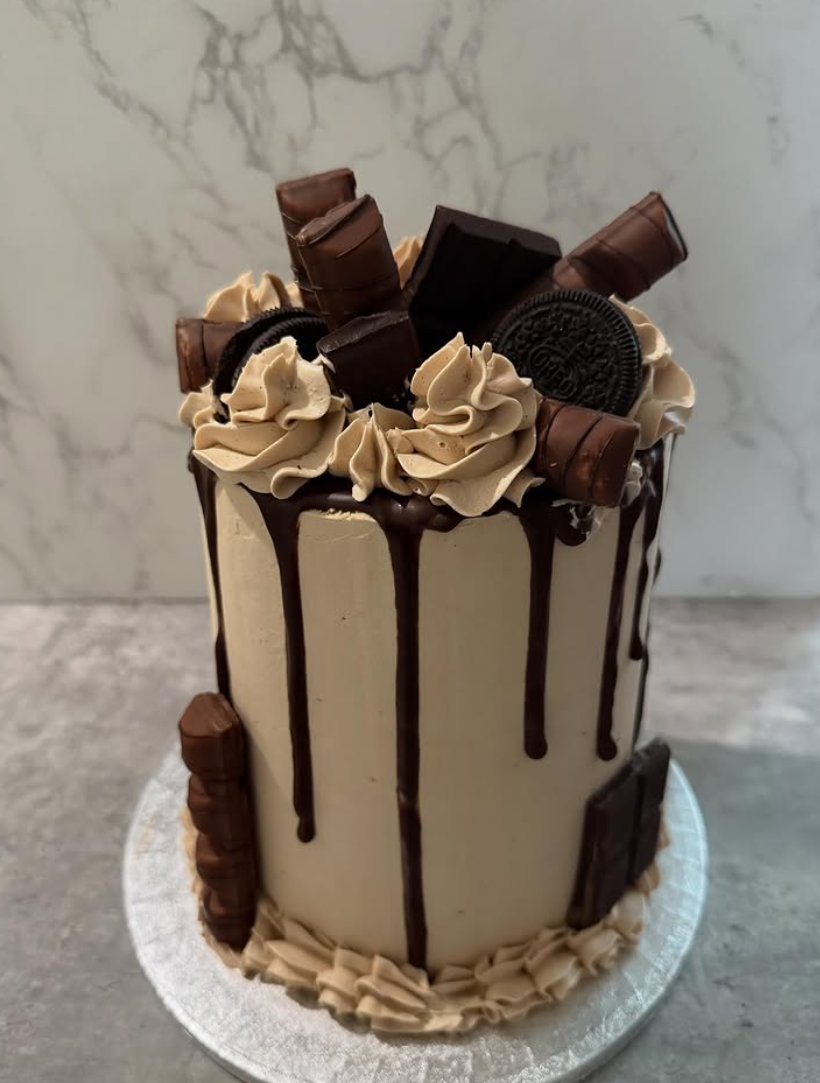 Chocolate drip cake loaded with Kinder bars, Oreos and buttercream swirls
